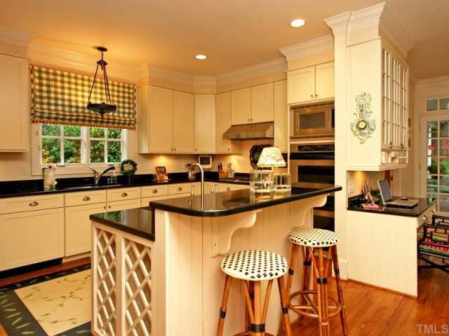 2305 Anderson Drive Raleigh, NC 27609 - Photo 5 of 12 Solid surface counters, stainless steel appliances, gas cooktop and built-in ovens.