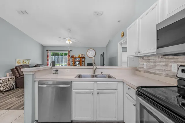 a kitchen with a sink stove and cabinets