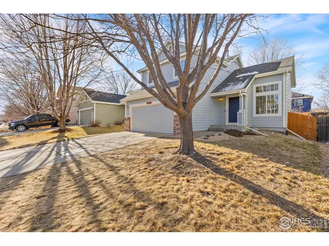 a view of a house with a yard covered in snow