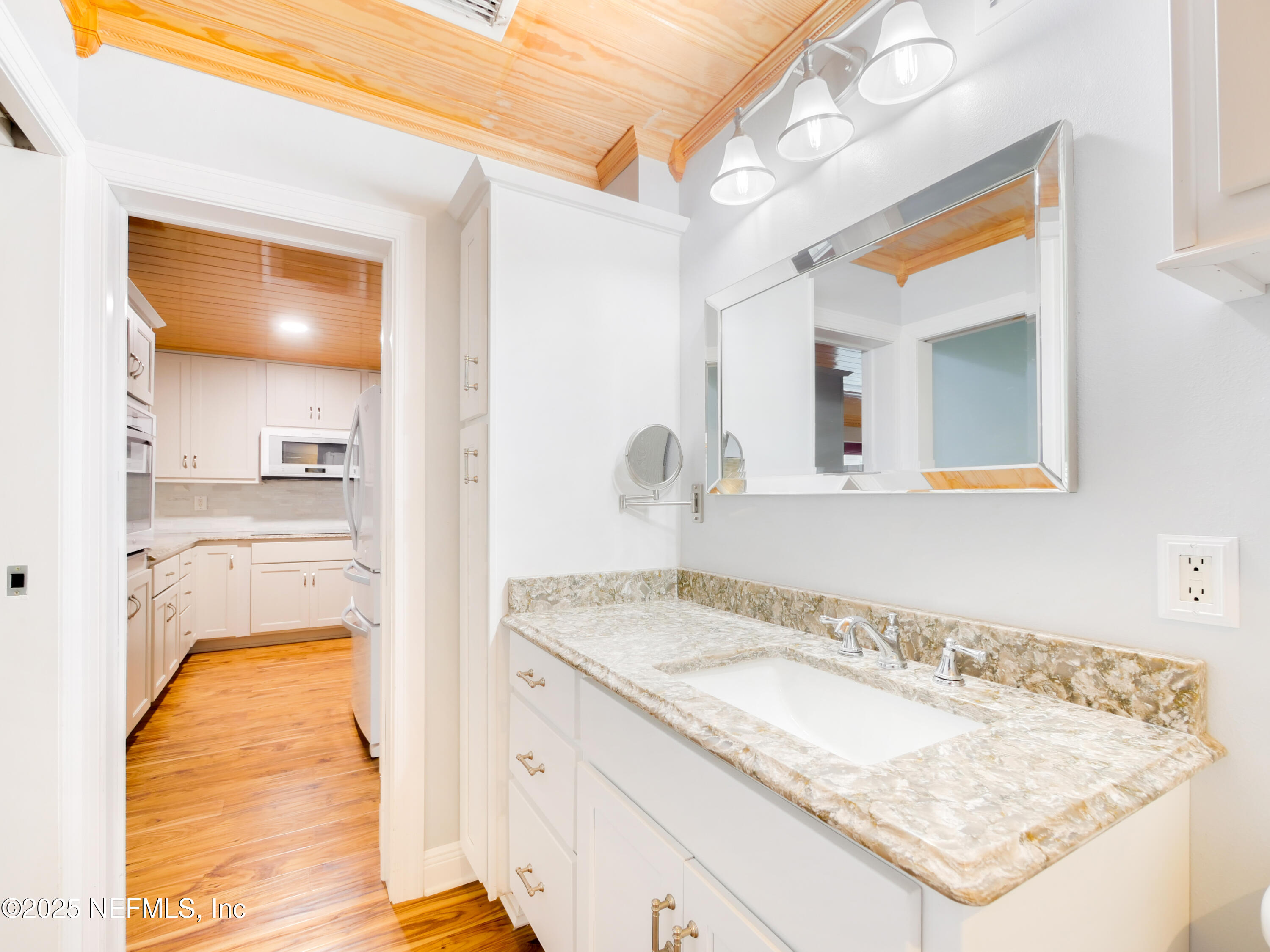 6472 Putnam Street St. Augustine, FL 32080 - Photo 14 of 26 a en suite bathroom with a granite countertop sink and a mirror