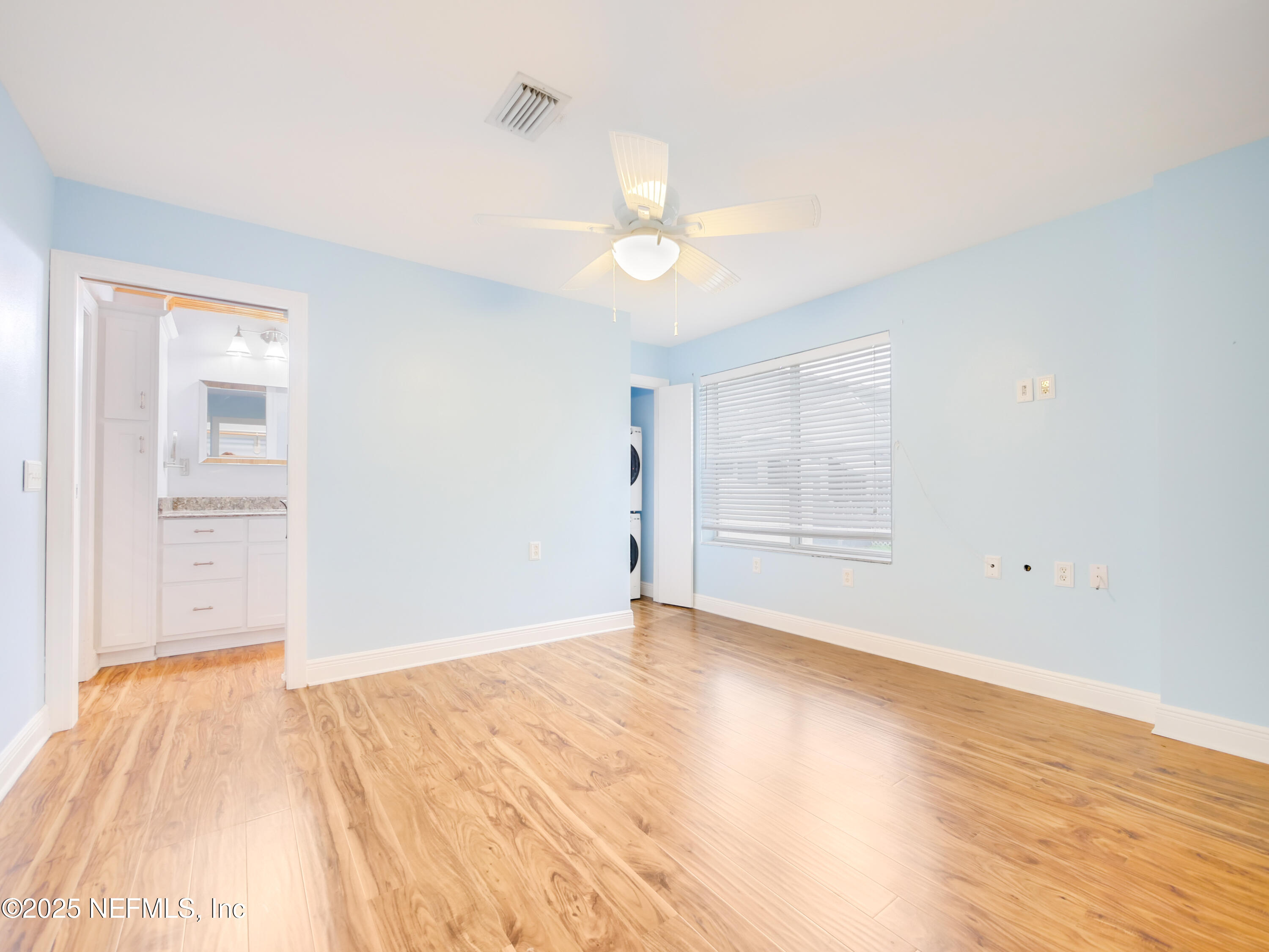6472 Putnam Street St. Augustine, FL 32080 - Photo 17 of 26 an empty room with wooden floor cabinet and windows