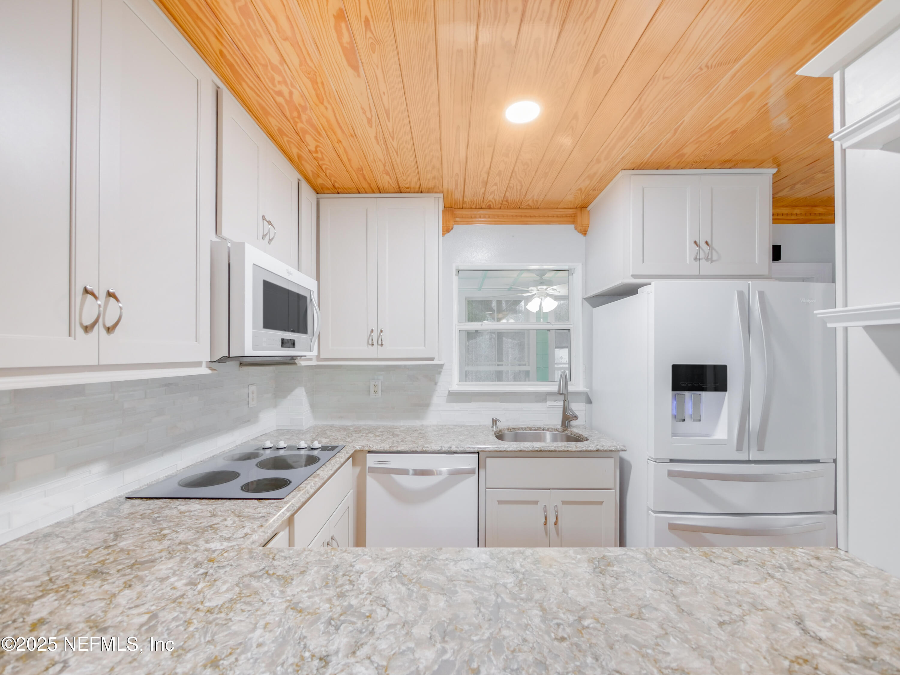 6472 Putnam Street St. Augustine, FL 32080 - Photo 26 of 26 a kitchen with stainless steel appliances granite countertop a sink a stove and a refrigerator