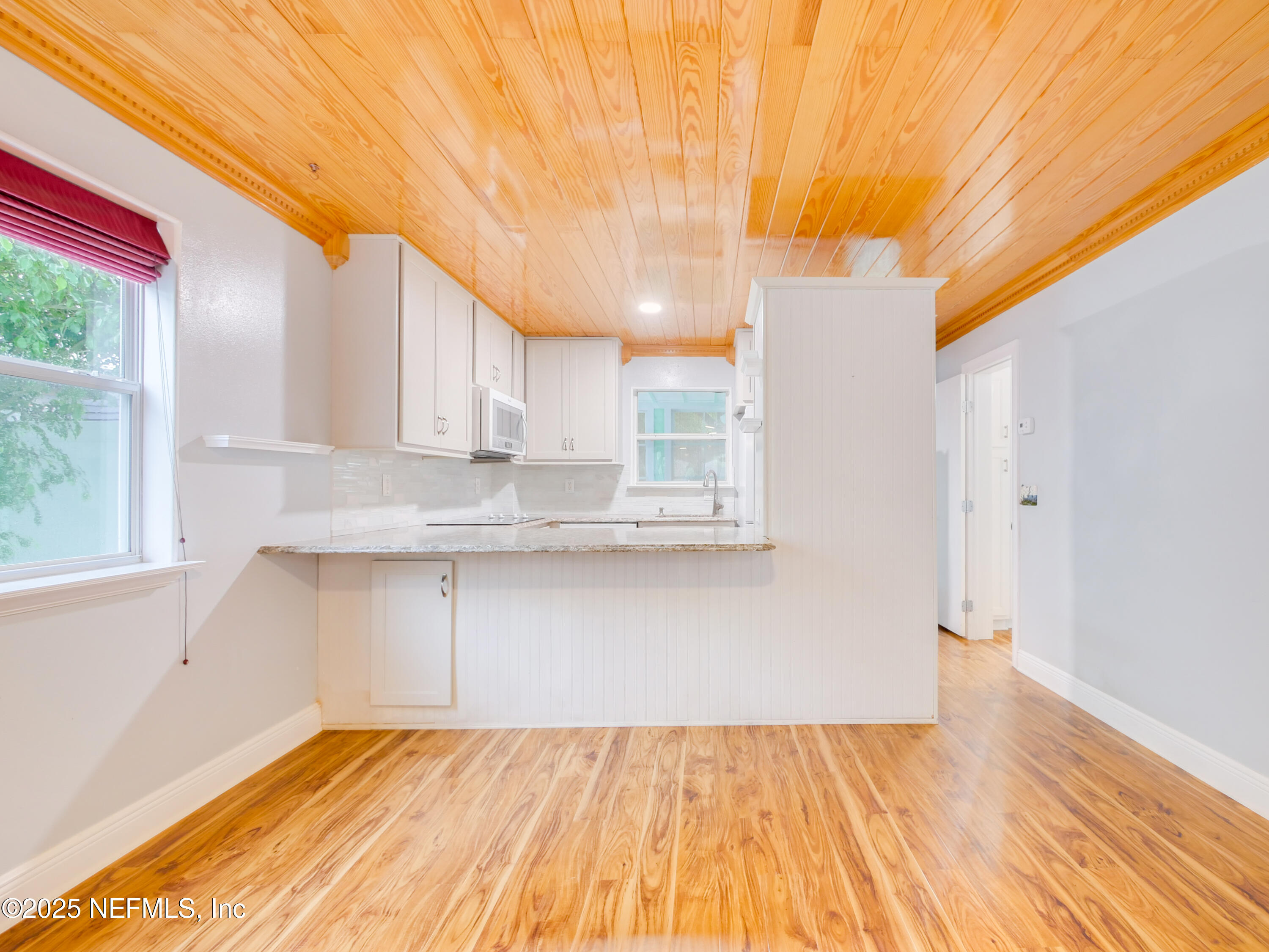6472 Putnam Street St. Augustine, FL 32080 - Photo 5 of 26 a view of a kitchen with wooden floor and cabinets