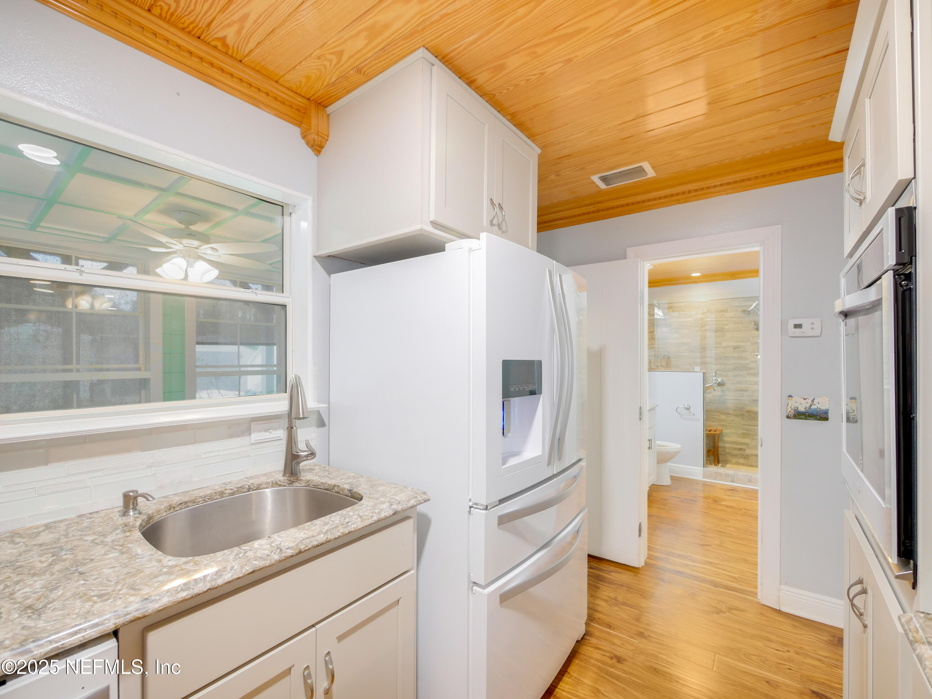 6472 Putnam Street St. Augustine, FL 32080 - Photo 9 of 26 a kitchen with a sink and refrigerator