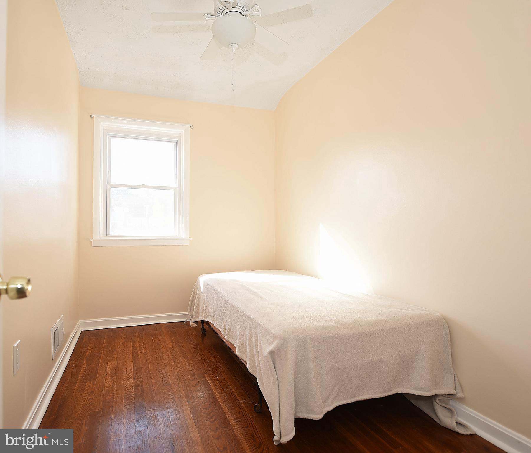 4423 Fenor Road Baltimore, MD 21227 - Photo 18 of 28 a bedroom with a bed and a window