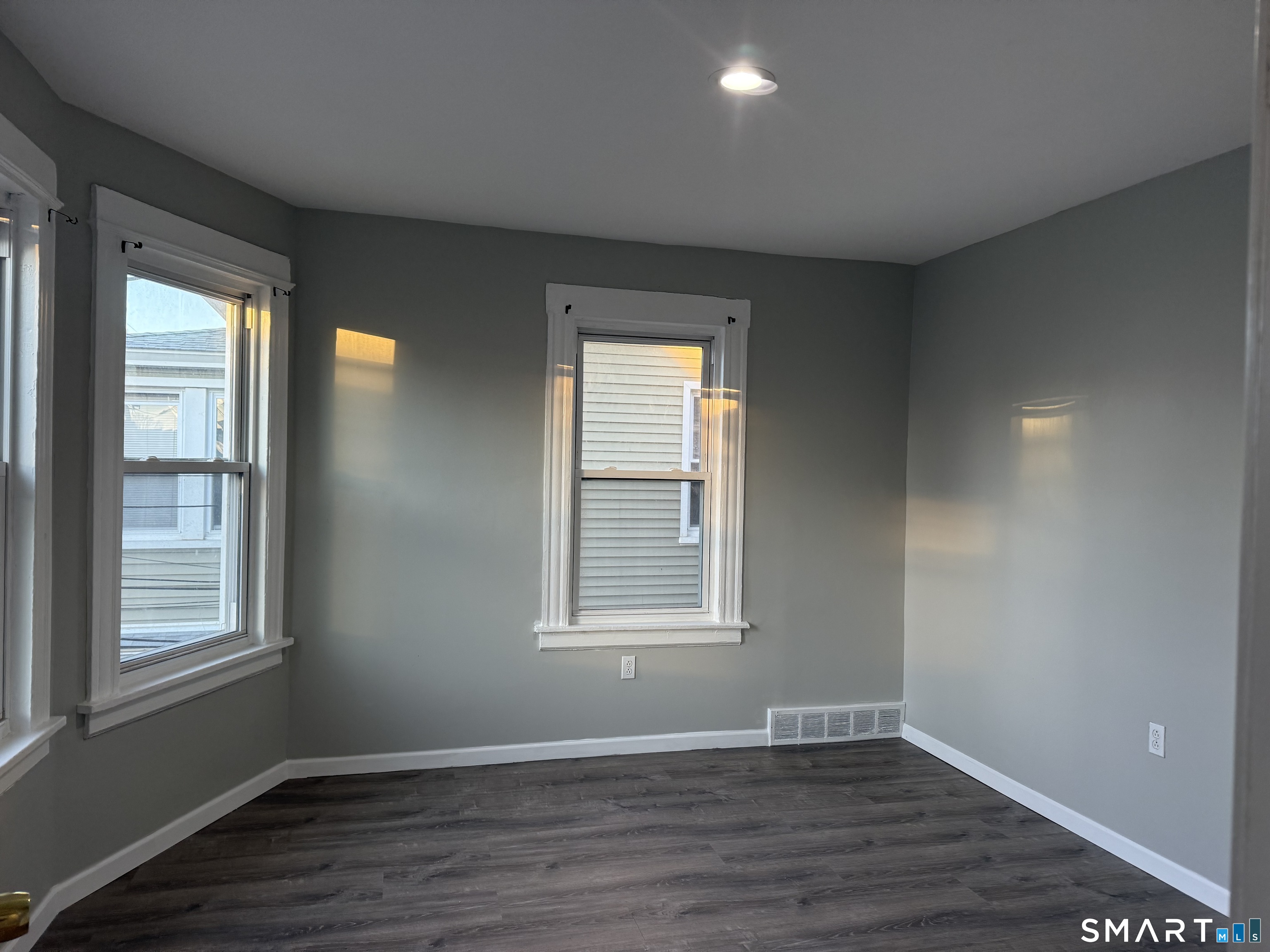 276 Orchard Street Bridgeport, CT 06608 - Photo 11 of 14 a view of an empty room with wooden floor and a window