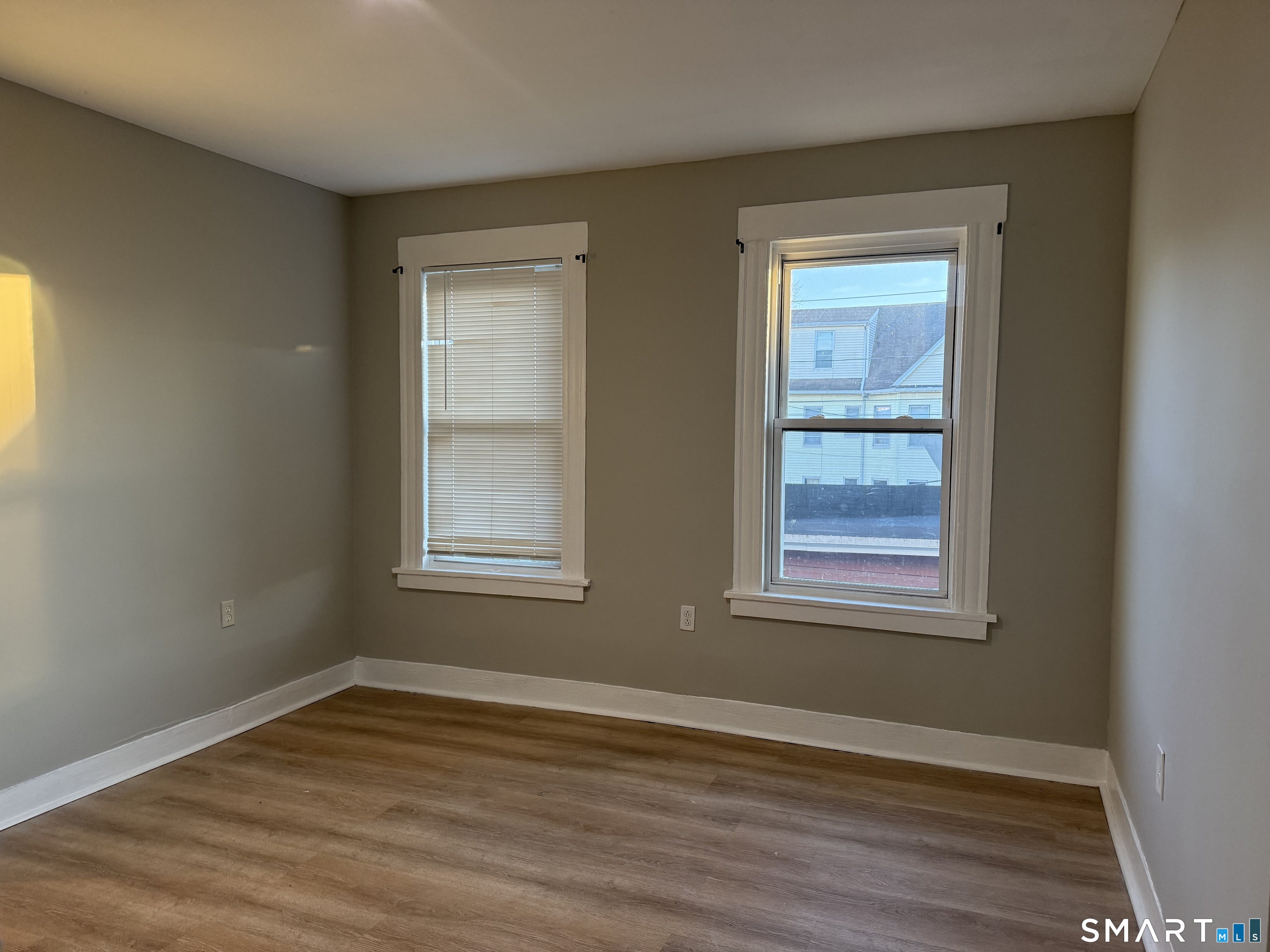 276 Orchard Street Bridgeport, CT 06608 - Photo 12 of 14 a view of an empty room with wooden floor and a window
