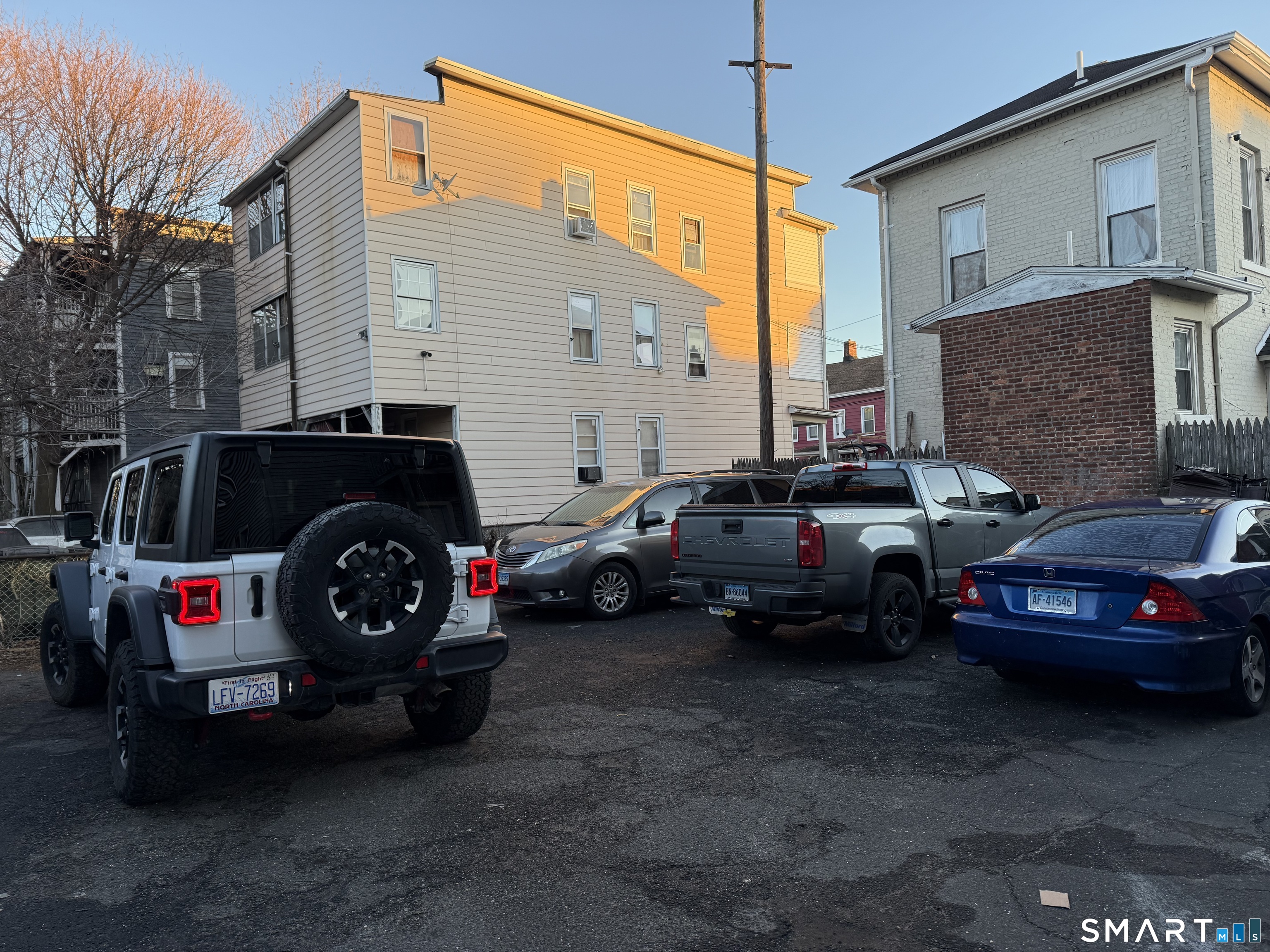 276 Orchard Street Bridgeport, CT 06608 - Photo 14 of 14 a car parked in front of a house