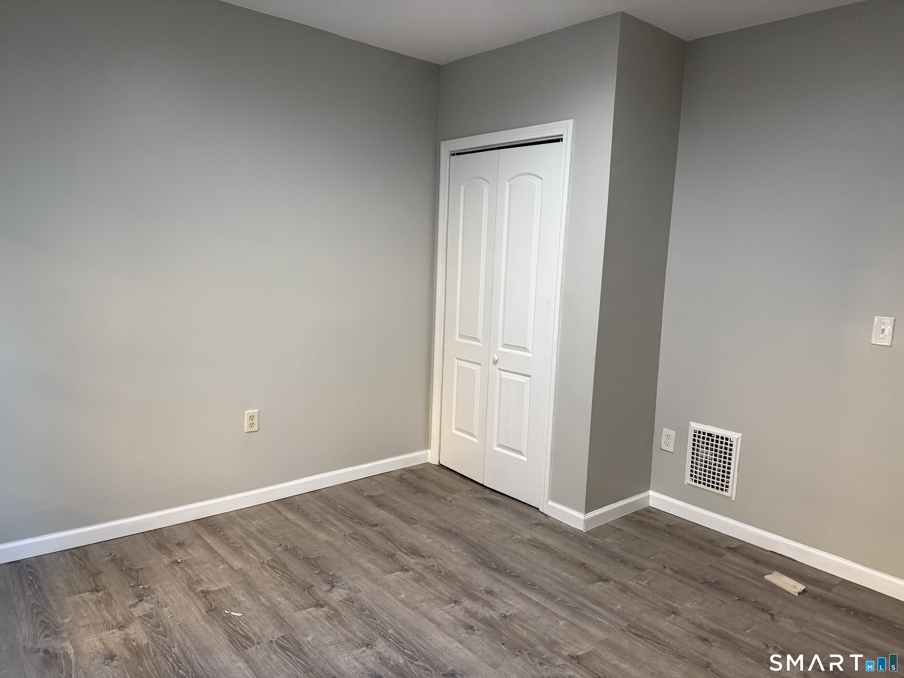 276 Orchard Street Bridgeport, CT 06608 - Photo 5 of 14 a view of an empty room with wooden floor