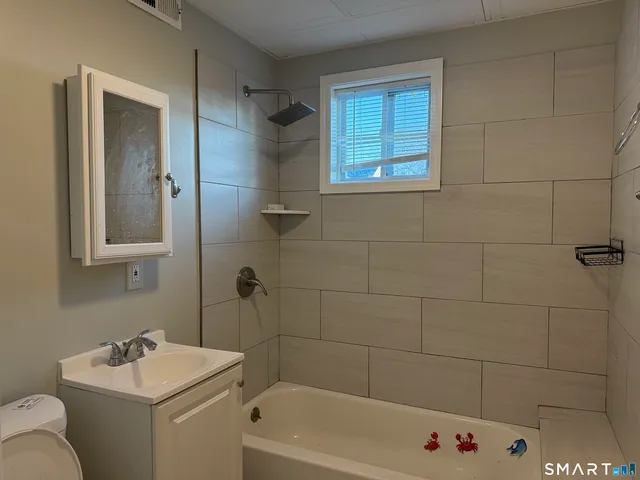 a bathroom with a sink toilet and shower