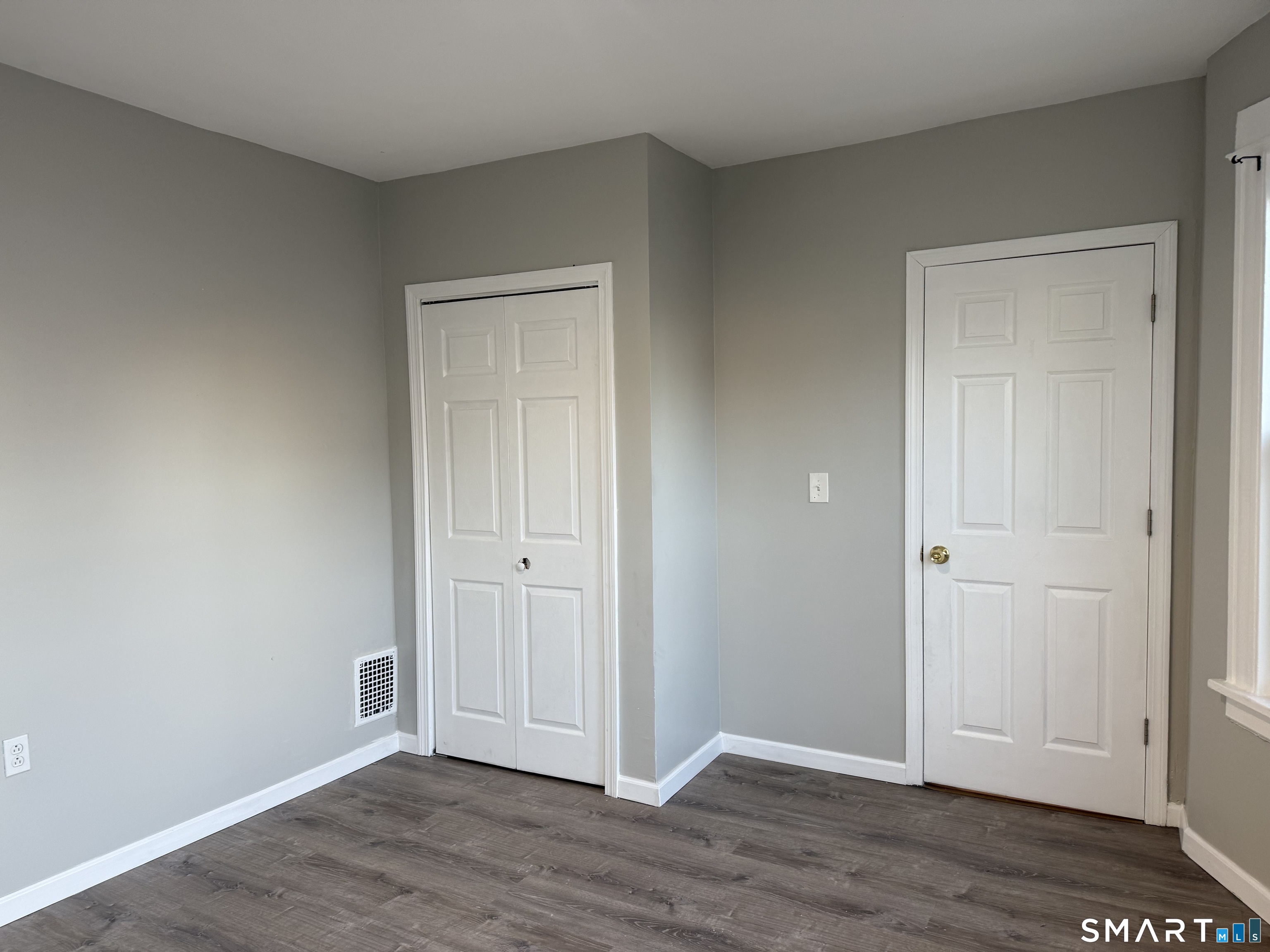 276 Orchard Street Bridgeport, CT 06608 - Photo 10 of 14 a view of empty room with wooden floor
