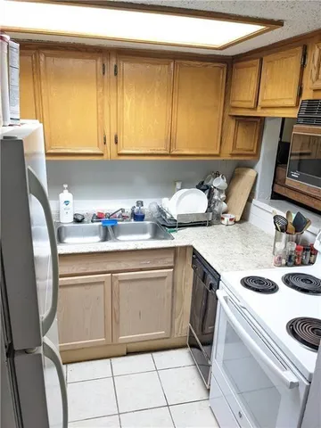 a kitchen with a sink cabinets and appliances