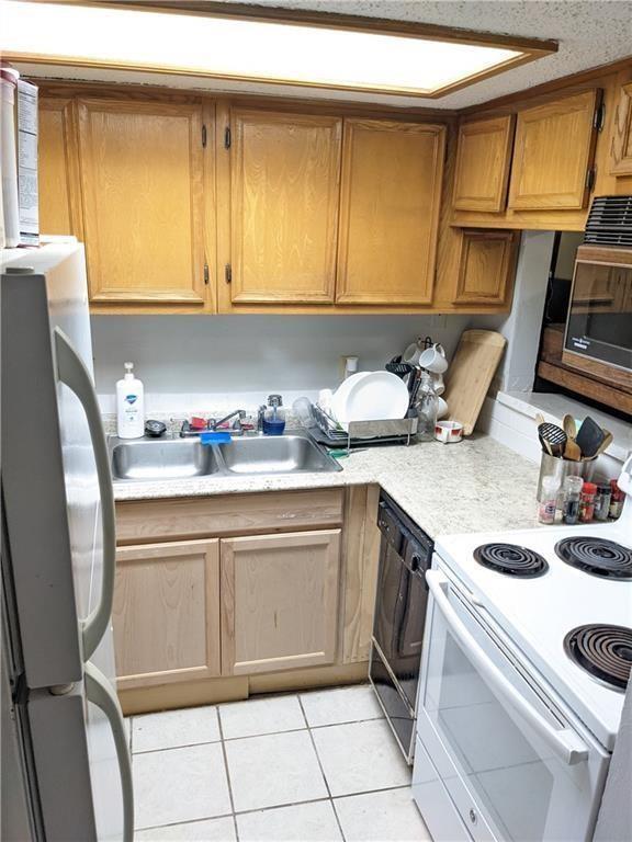 3506 Speedway, Unit 104 Austin, TX 78705 - Photo 2 of 4 a kitchen with a sink cabinets and appliances