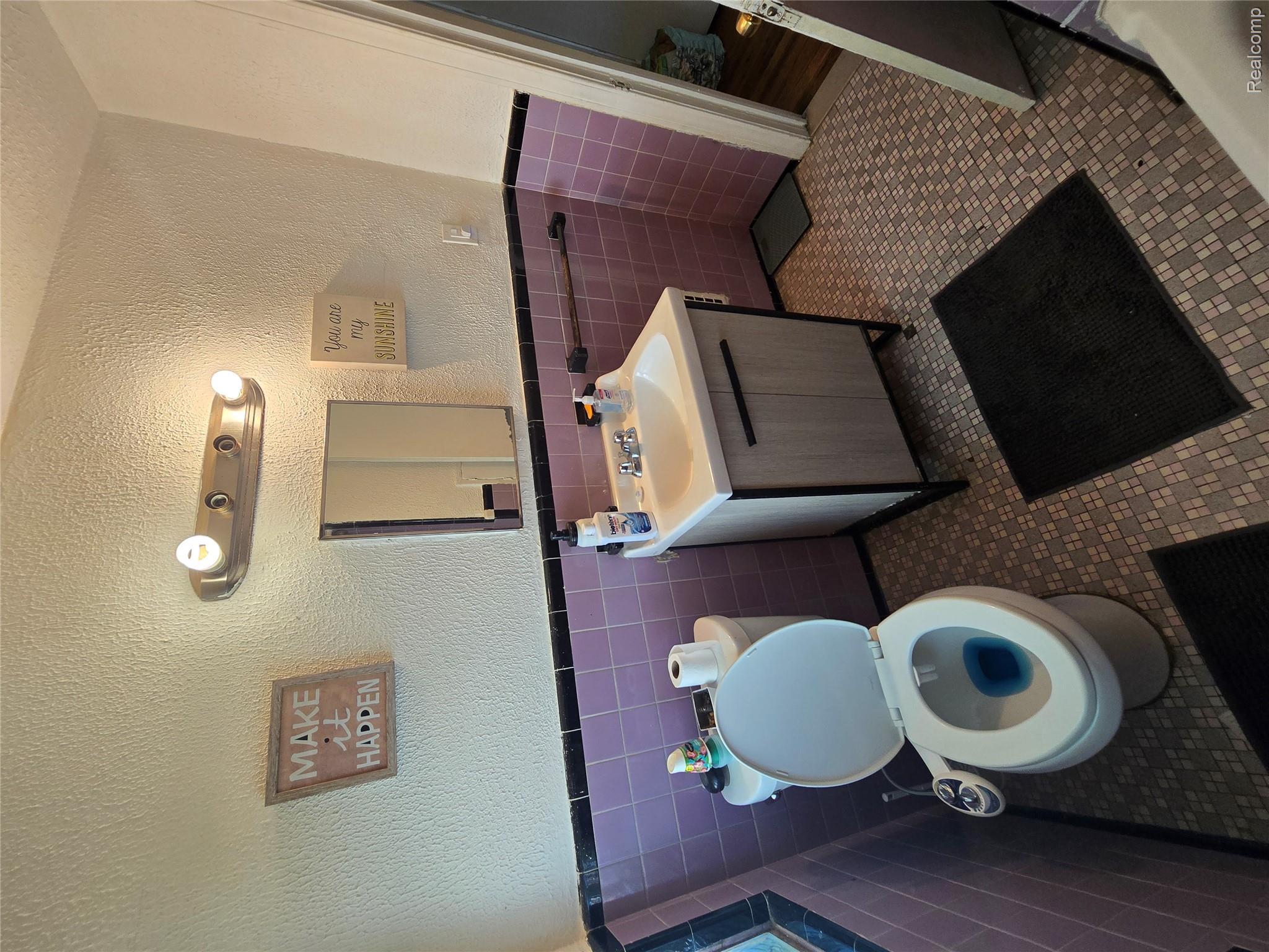 10342 Roxbury Street Detroit, MI 48224 - Photo 18 of 30 Vanity with integrated sink, patterned floor tiling, and wall-mounted light fixture