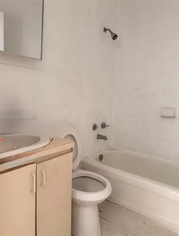 a bathroom with a sink a toilet and bathtub