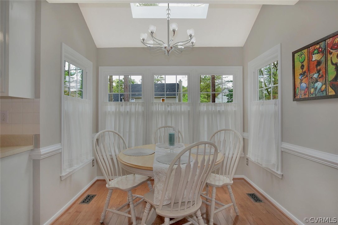 5717 Laurel Trail Road Midlothian, VA 23112 - Photo 15 of 28 a view of a dining room with furniture a chandelier and wooden floor