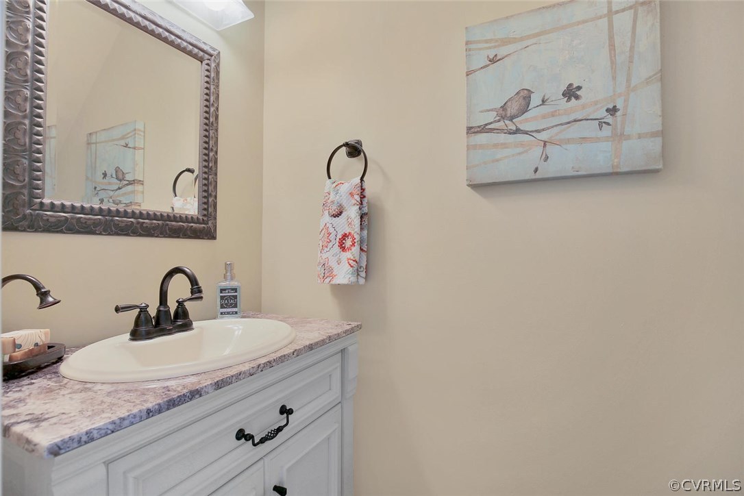 5717 Laurel Trail Road Midlothian, VA 23112 - Photo 17 of 28 a bathroom with a sink and a mirror
