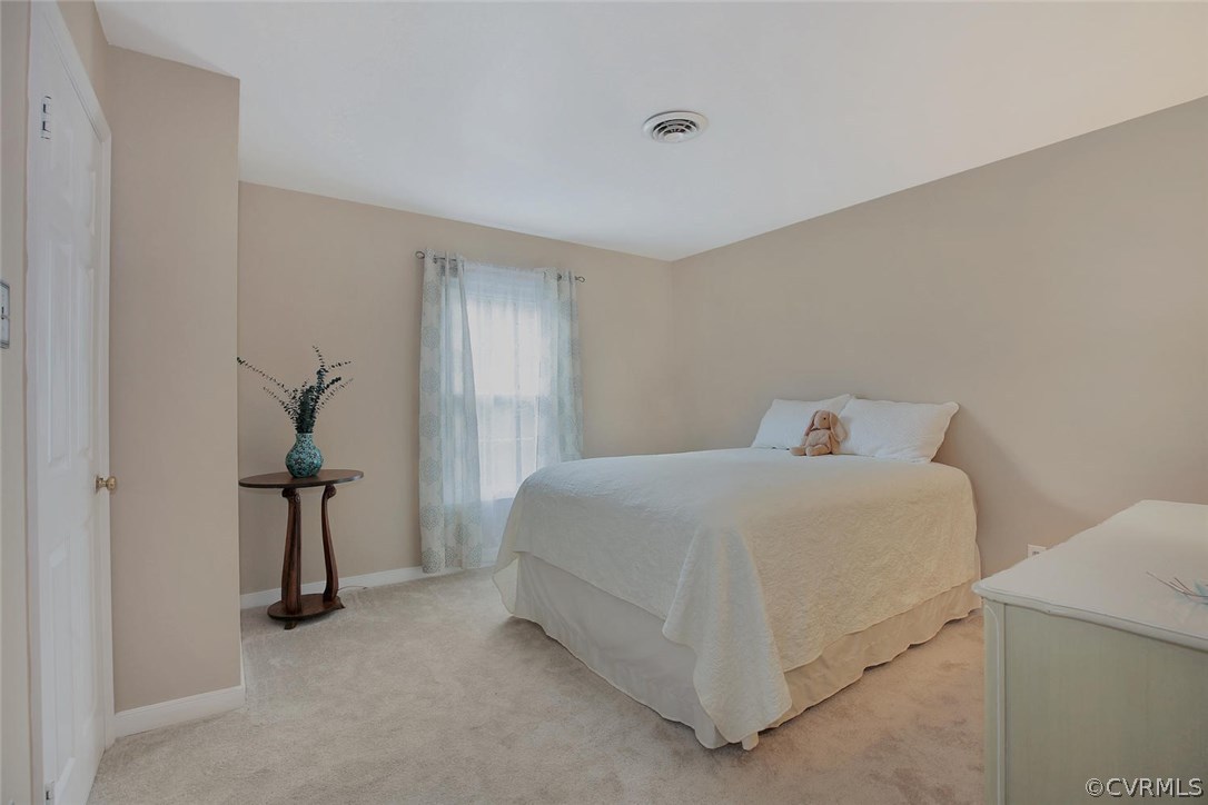 5717 Laurel Trail Road Midlothian, VA 23112 - Photo 22 of 28 a bedroom with a bed and a chandelier