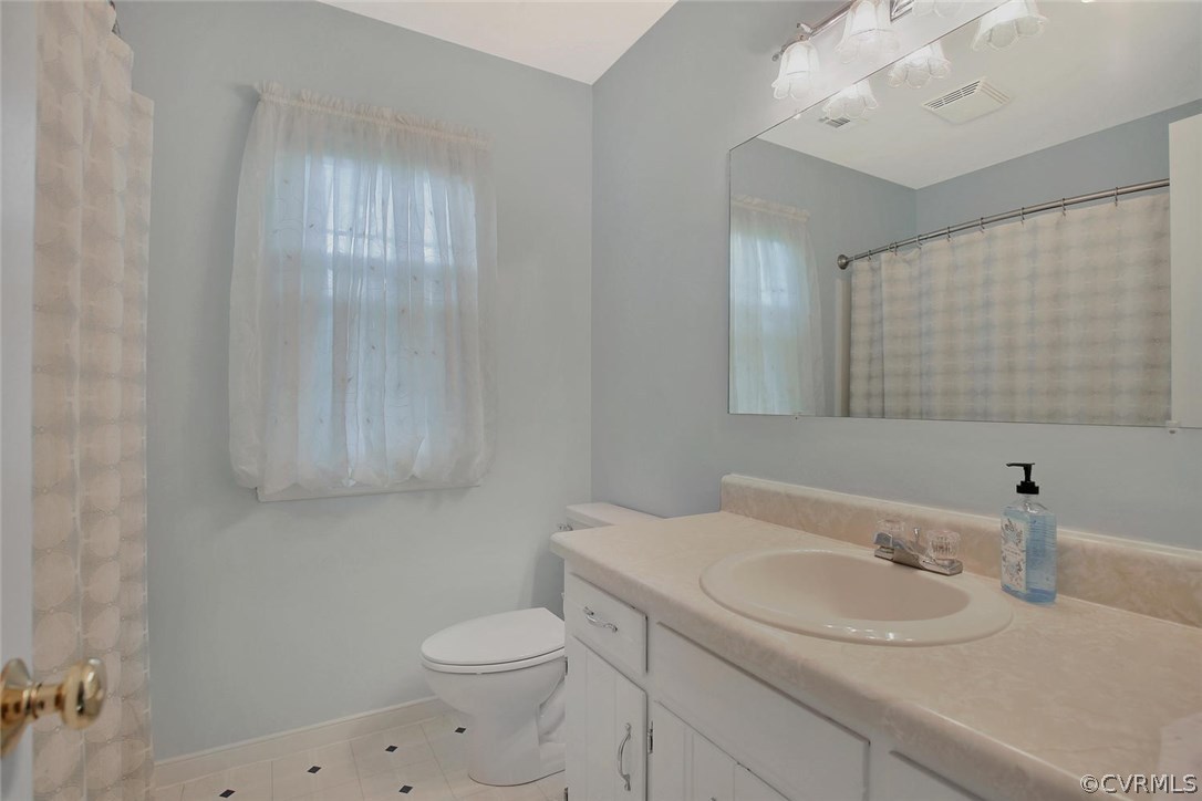 5717 Laurel Trail Road Midlothian, VA 23112 - Photo 24 of 28 a bathroom with a sink a toilet and mirror