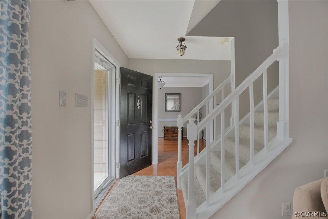 5717 Laurel Trail Road Midlothian, VA 23112 - Photo 3 of 28 a view of staircase with lots of frames on wall and a window