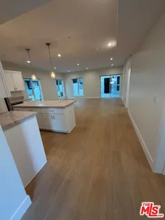 a kitchen with stainless steel appliances a refrigerator and a counter top space