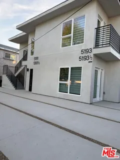 a front view of a house with large windows