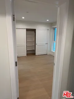 a view of an empty room and a bathroom