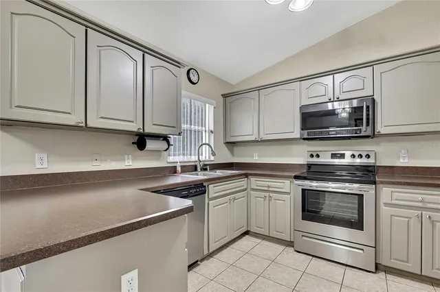 a kitchen with a sink stove and microwave