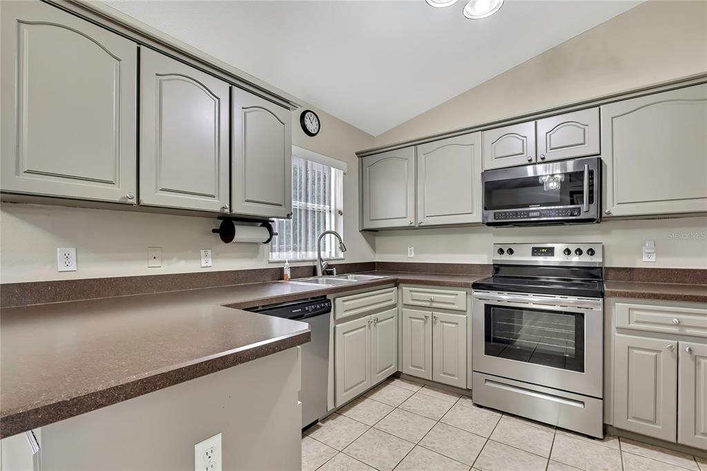 103 Daisy Lane Inverness, FL 34452 - Photo 11 of 40 a kitchen with a sink stove and microwave