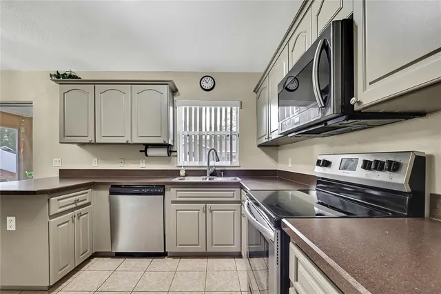 a kitchen with stainless steel appliances granite countertop a sink and cabinets