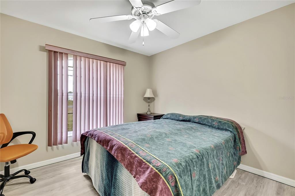 103 Daisy Lane Inverness, FL 34452 - Photo 18 of 40 a bedroom with a bed and a chandelier