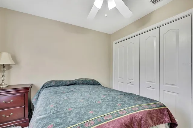 a bedroom with a bed a desk and chair