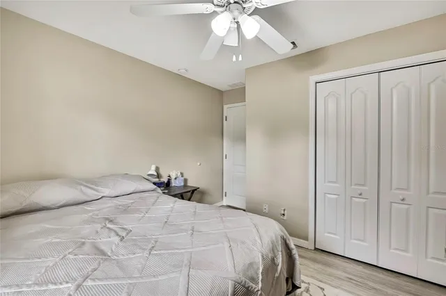 a view of a chairs and table in patio with a swimming pool