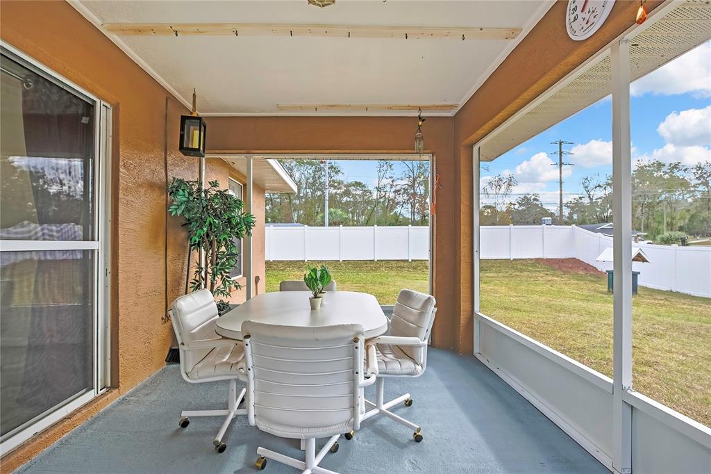 103 Daisy Lane Inverness, FL 34452 - Photo 26 of 40 a dining room with furniture and garden view