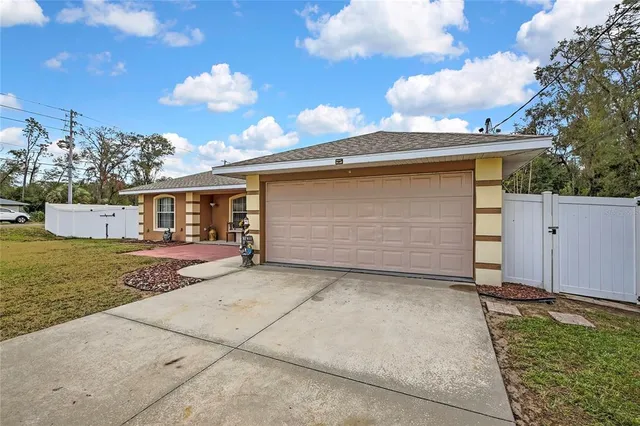 a front view of a house with yard and green space