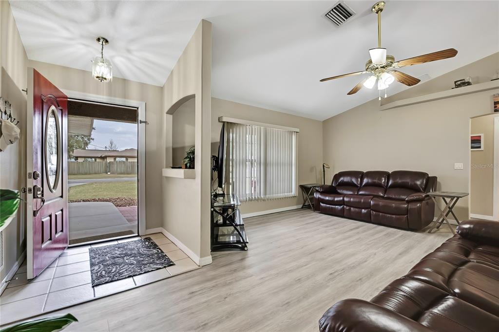 103 Daisy Lane Inverness, FL 34452 - Photo 4 of 40 a living room with furniture and a chandelier
