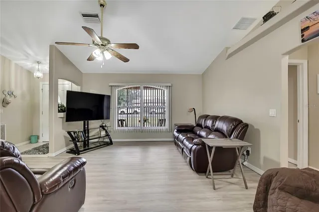 a living room with furniture window and a flat screen tv