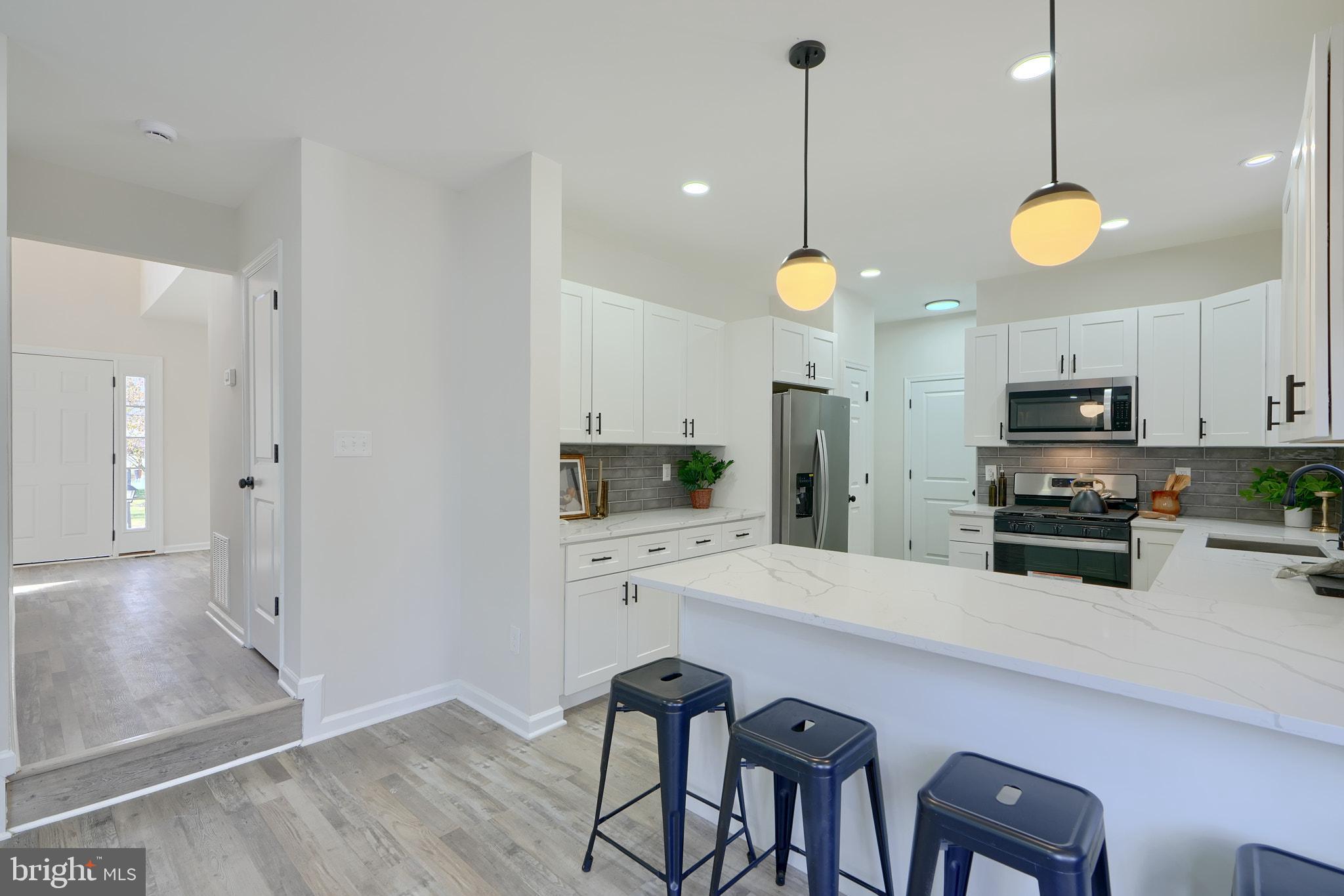 2801 Claybrooke Drive Windsor Mill, MD 21244 - Photo 21 of 63 Ample peninsula with quartz and pendants