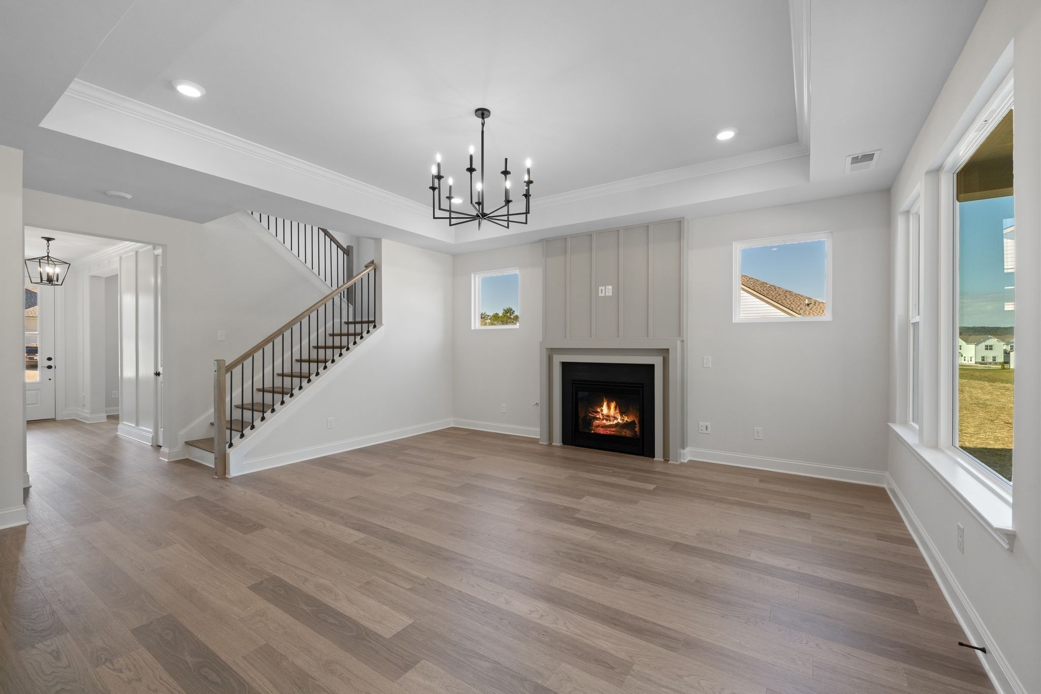 7318 Winners Road Murfreesboro, TN 37129 - Photo 14 of 44 a view of an empty room with wooden floor fireplace and a window