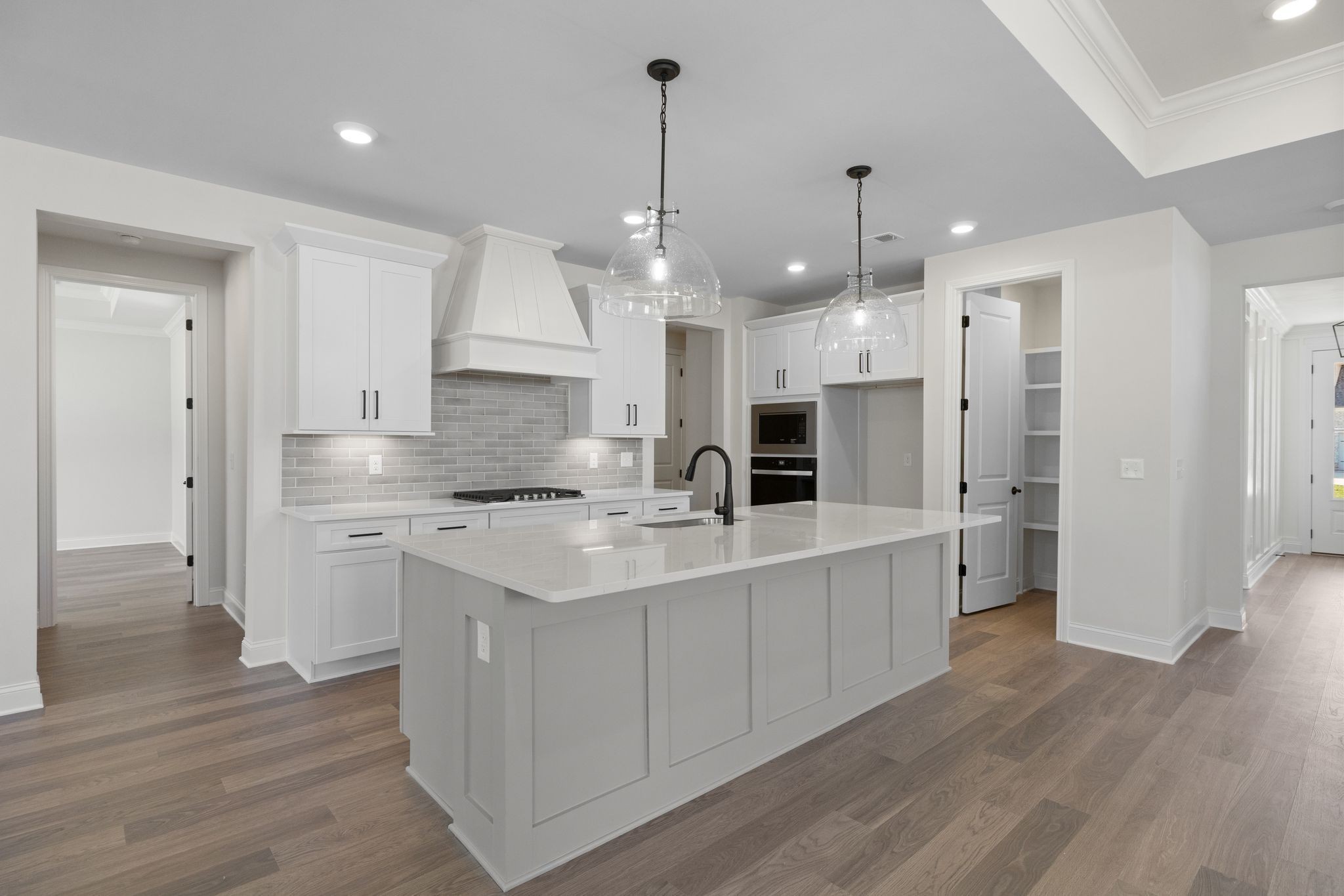 7318 Winners Road Murfreesboro, TN 37129 - Photo 17 of 44 a large kitchen with stainless steel appliances a large center island wooden floor and stove