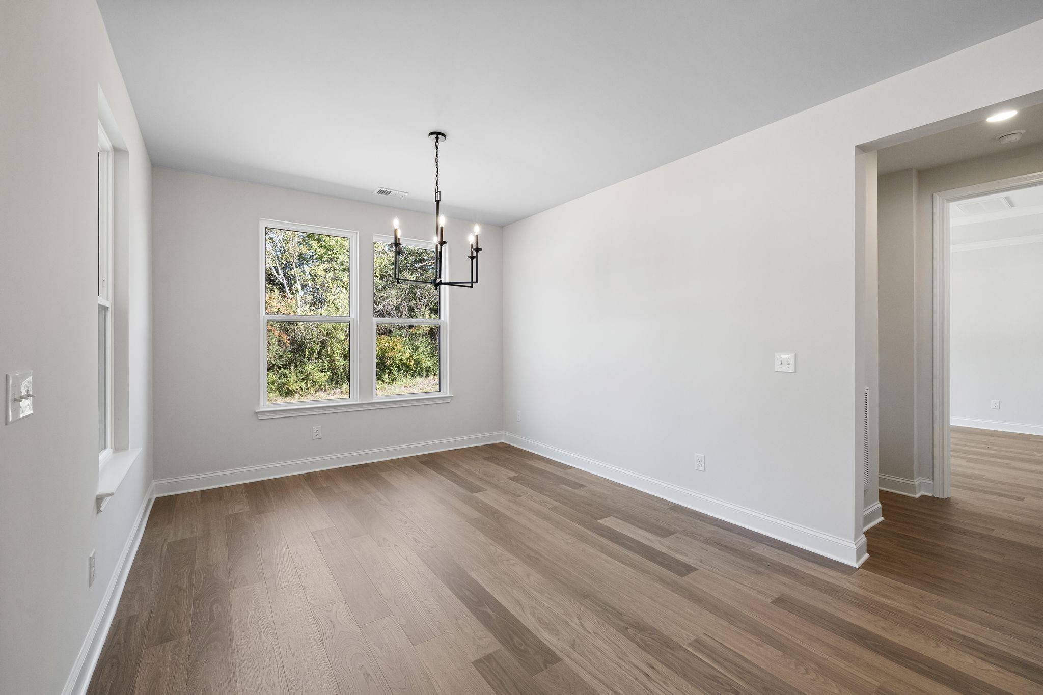 7318 Winners Road Murfreesboro, TN 37129 - Photo 19 of 44 an empty room with wooden floor and windows