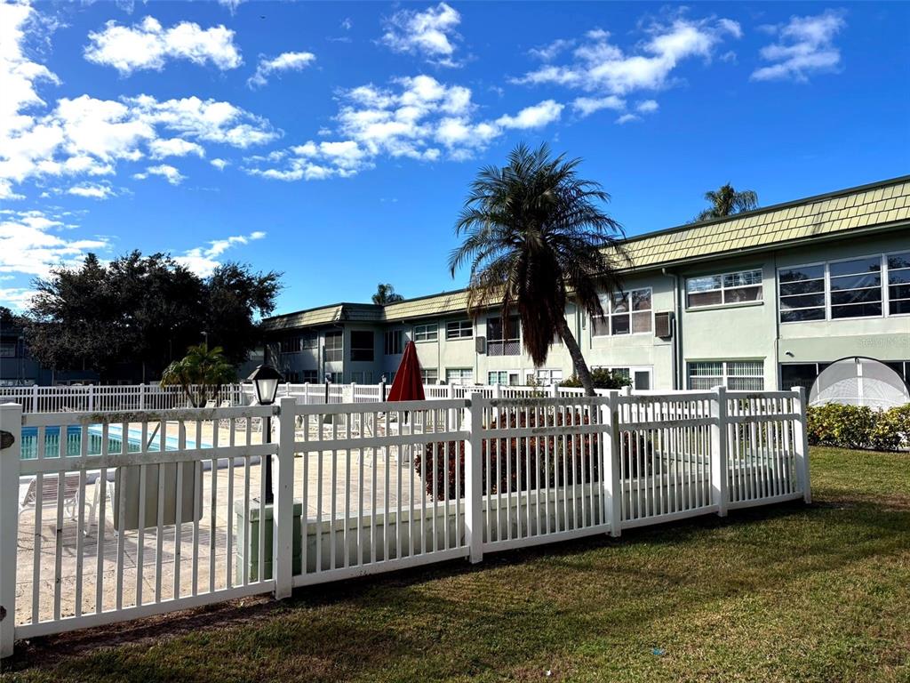 1433 South Belcher Road, Unit B2 Clearwater, FL 33764 - Photo 20 of 20 a view of a house with a wooden deck and a yard