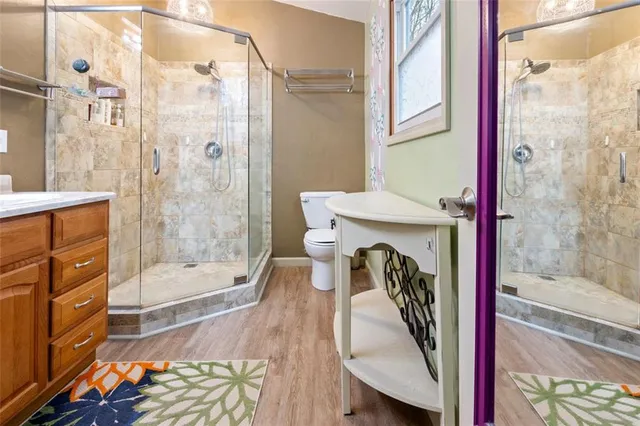 a bathroom with a sink a toilet and shower