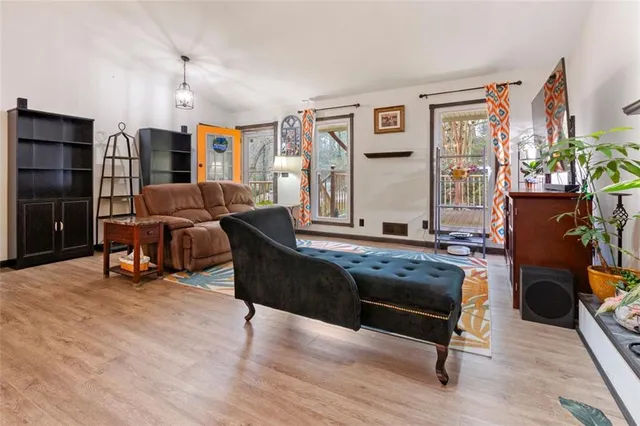 a living room with furniture a piano and a flat screen tv