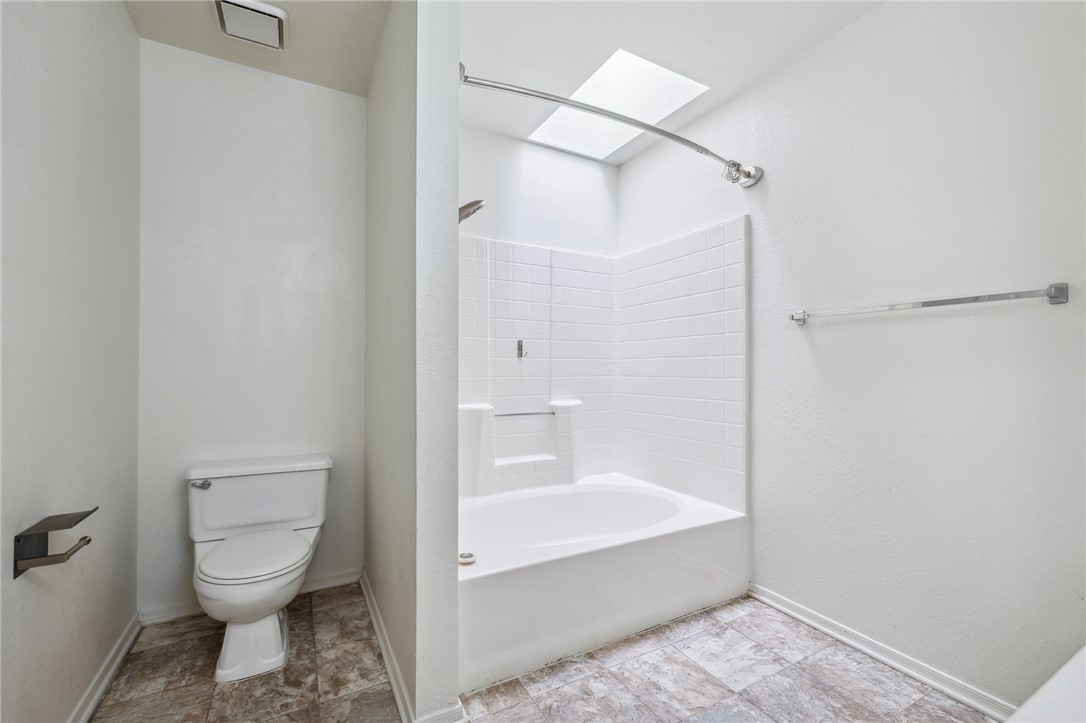 2524 South Ridge Avenue Bullhead City, AZ 86429 - Photo 32 of 64 Full bath with toilet, shower / bathtub combination, baseboards, and a skylight
