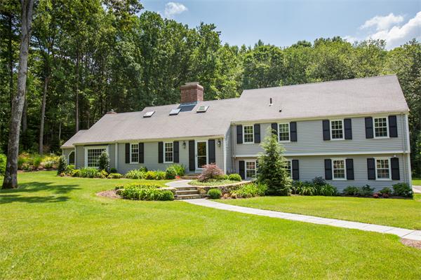 4 Squirrel Hill Road Wayland, MA 01778 - Photo 1 of 23 a front view of a house with a garden