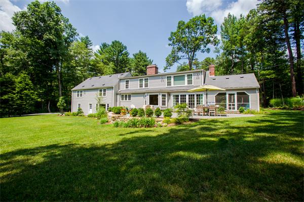 4 Squirrel Hill Road Wayland, MA 01778 - Photo 23 of 23 a front view of a house with a yard table and chairs