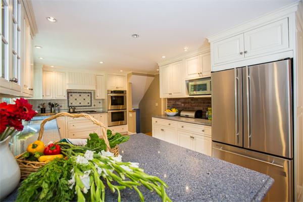 4 Squirrel Hill Road Wayland, MA 01778 - Photo 8 of 23 a kitchen with granite countertop a refrigerator and a stove top oven