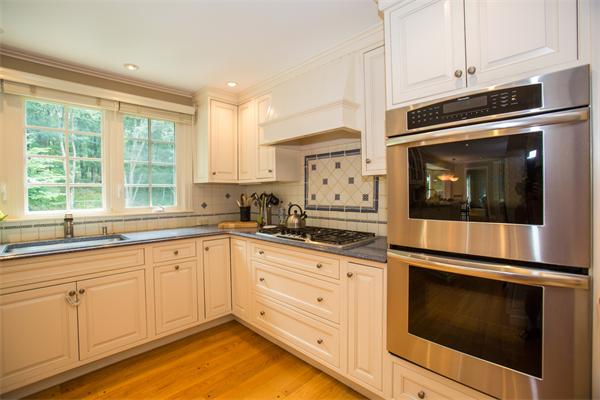 4 Squirrel Hill Road Wayland, MA 01778 - Photo 9 of 23 a kitchen with granite countertop white cabinets stainless steel appliances and a window