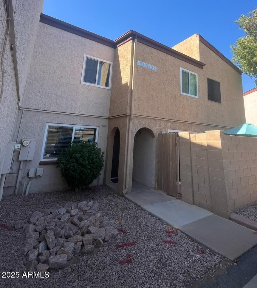 1455 North Alma School Road, Unit 11 Mesa, AZ 85201 - Photo 1 of 22 a view of a house with a yard and plants